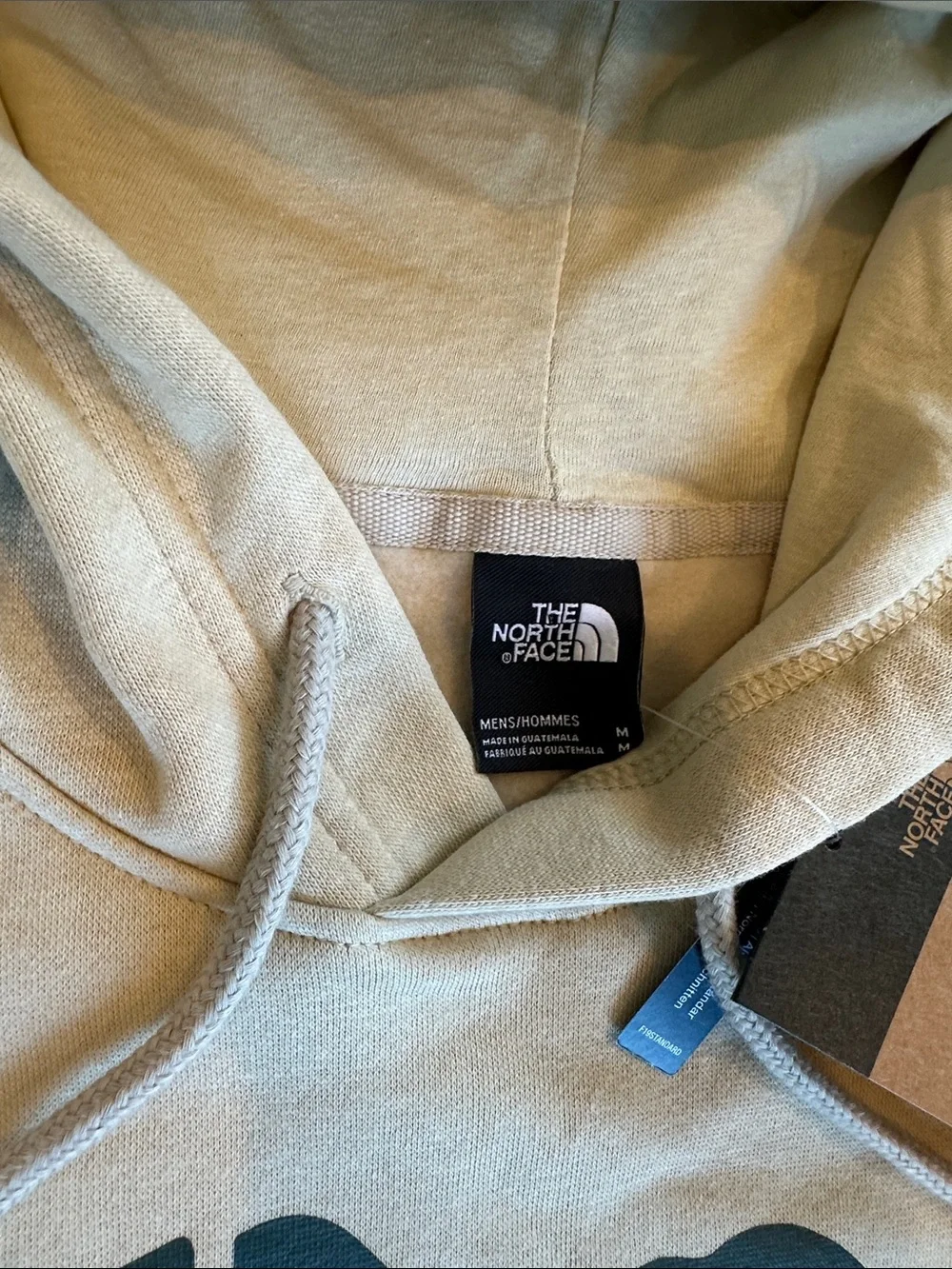 The North Face Cream Hoodie with Green Bear Logo